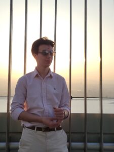 Michael Roberts is standing outside. He is wearing sunglasses.