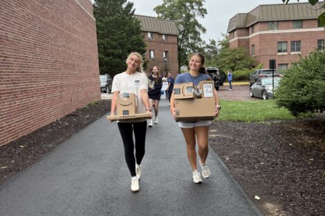 Two girls are moving boxes