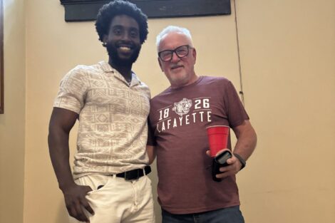 James Boateng (Zeta Psi President) and Joe Maddon '76 stand on the stairs in the Zeta Psi house.